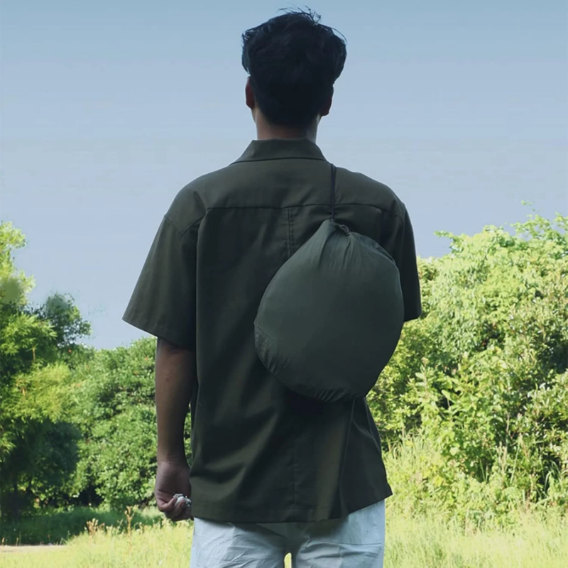 Portable hammock with mosquito net packed into a small stuff sack for hiking