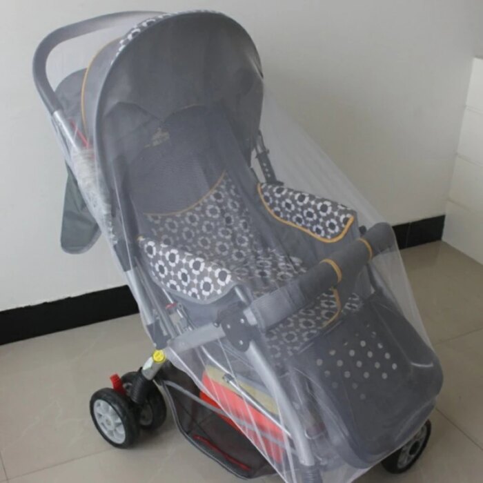 Baby stroller with mosquito net installed for a park visit