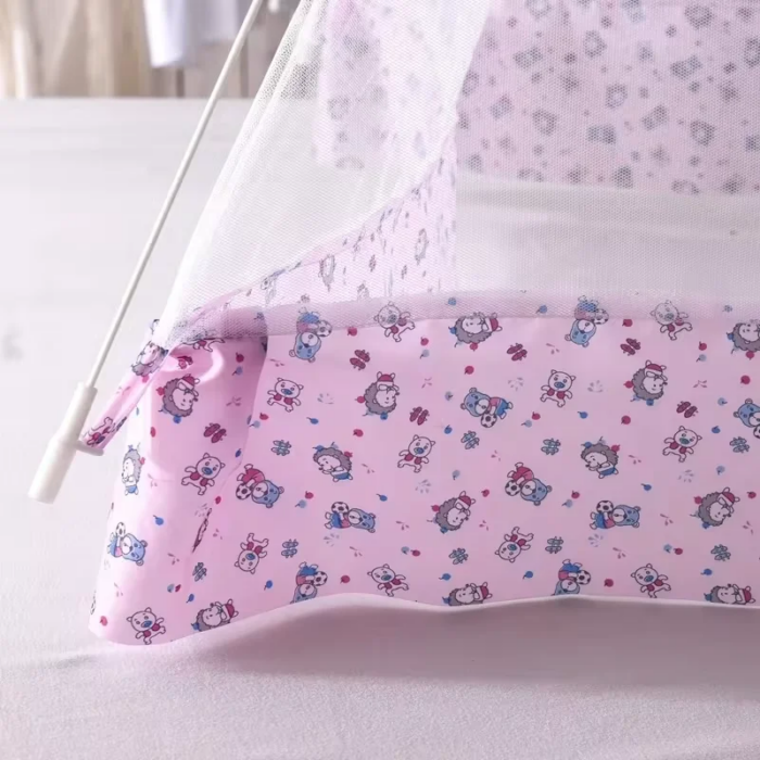 Mother adjusting the cute printed mosquito net over a baby playpen