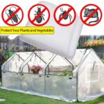 White agfabric mosquito netting covering a tomato plant in a garden
