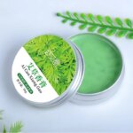 Close-up of the green mugwort balm texture in a 30g box