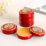 Close-up of the 3g solid balm texture in a red compact box