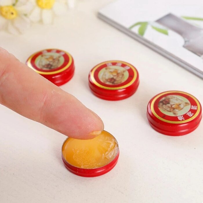 Close-up of the 3g solid balm texture in a red compact box